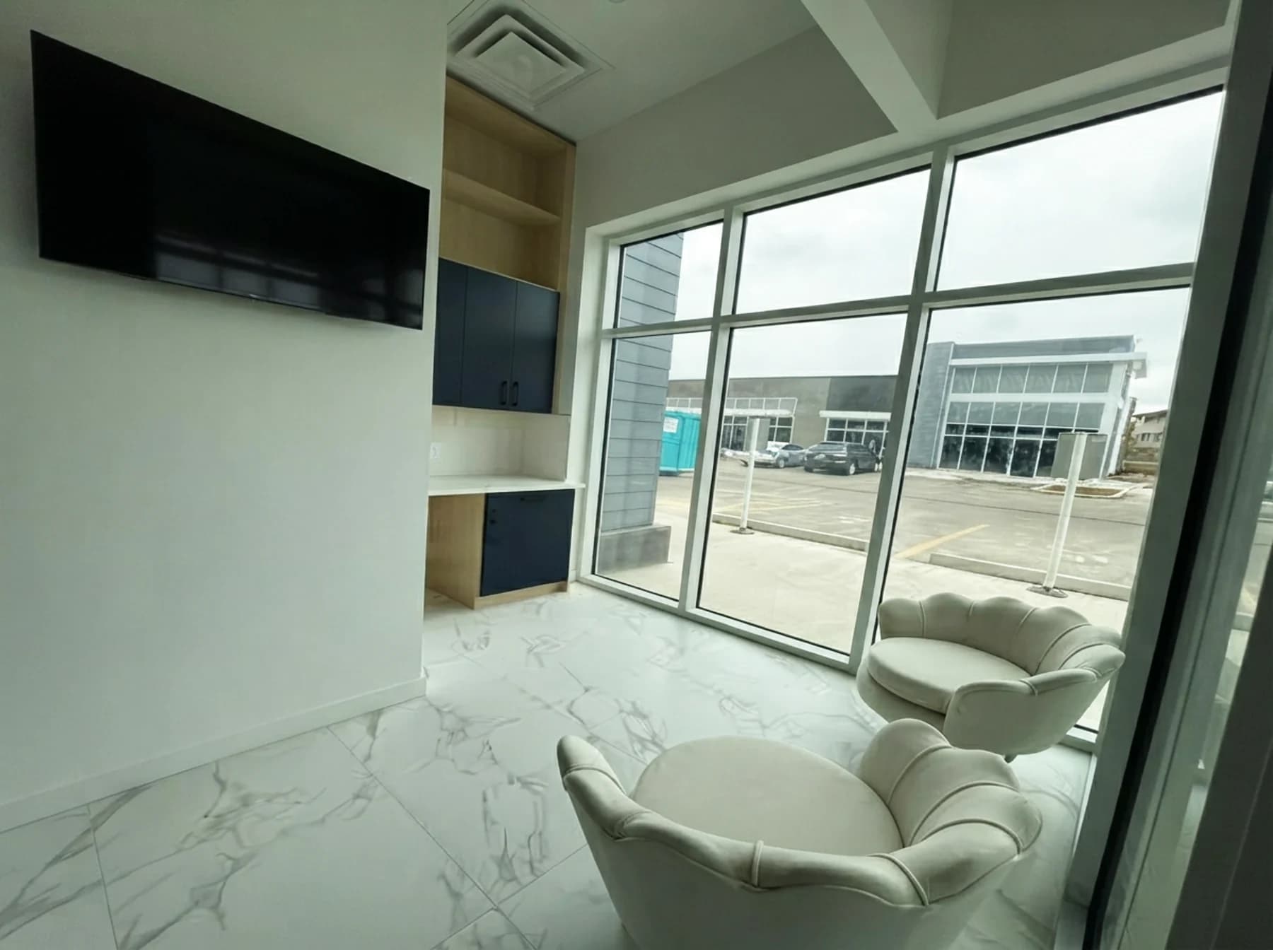 Comfortable patient lounge with seating and television at Cy Becker Dental in NW Edmonton
