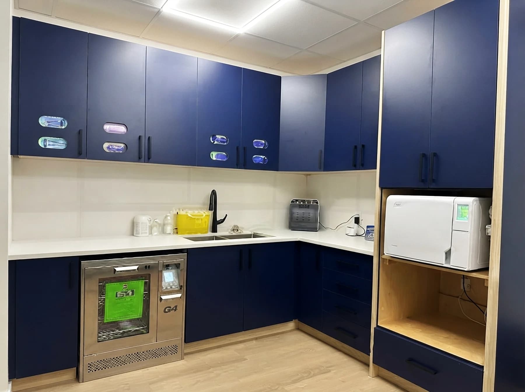Dedicated sterilization room with autoclave and instrument washer at Cy Becker Dental